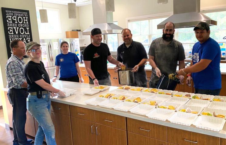 Falcon staff serve a meal to those staying at the Ronald McDonald House of Chapel Hill, supporting parents and loved ones who have a child going through an illness and/or treatment at nearby healthcare facilities.